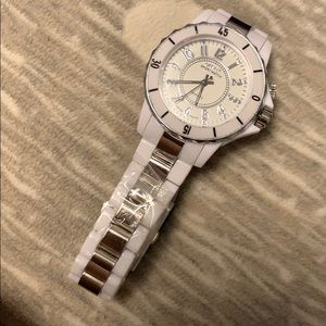 White fashion watch with stainless steel backing.